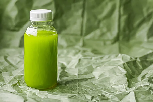 Fresh green juice in eco-friendly recyclable plastic bottle and packaging, healthy drink and food product