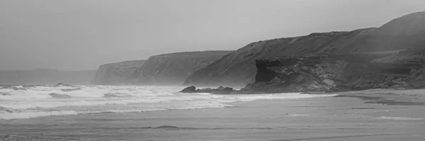 Beautiful landscape of ocean beach and mountains, black and white