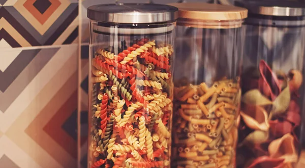 Pasta in dry food storage containers in the kitchen, pantry organisation and home decor