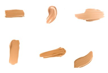 Beyaz arka plan, güzellik ve kozmetik üzerinde izole makyaj dokusu olarak sıvı temel lekeleri, lekeler, lekeler ve felçler