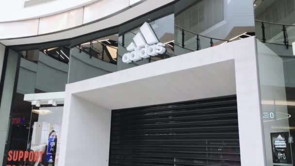 Stängt Adidas varumärke butik i ett köpcentrum under coronavirus covid-19 pandemisk lockdown, detaljhandel begränsning — Stockvideo