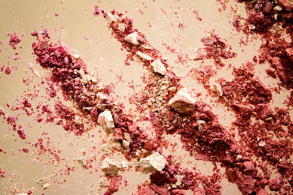 Crushed cosmetics, mineral organic eyeshadow, blush and cosmetic powder isolated on golden background, makeup and beauty banner, flatlay design