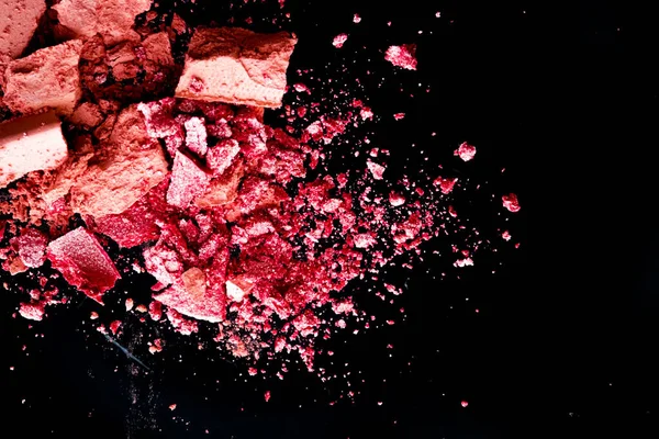 Crushed cosmetics, mineral organic eyeshadow, blush and cosmetic powder isolated on black background, makeup and beauty banner, flatlay design