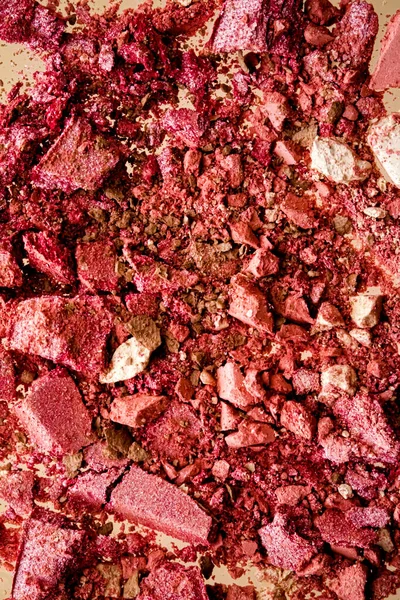 Crushed cosmetics, mineral organic eyeshadow, blush and cosmetic powder isolated on golden background, makeup and beauty banner, flatlay design