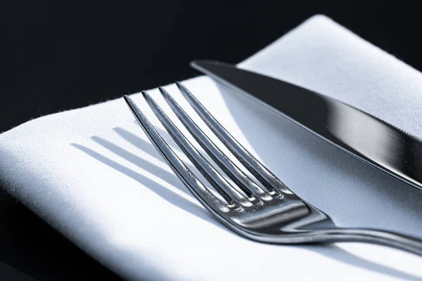 Fork and knife with white napkin on table in luxury restaurant outdoors, fine dining menu for wedding or event and food catering service concept — Stock Photo, Image