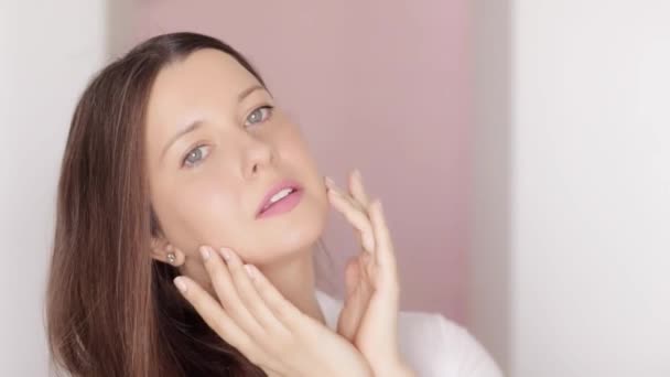 Belle femme touchant son visage, appliquant de la crème cosmétique bio avec des lignes de massage facial, une peau éclatante et saine et une routine naturelle de soins de la peau, une beauté anti-âge et un bien-être — Video