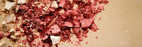 Crushed cosmetics, mineral organic eyeshadow, blush and cosmetic powder isolated on golden background, makeup and beauty banner, flatlay design