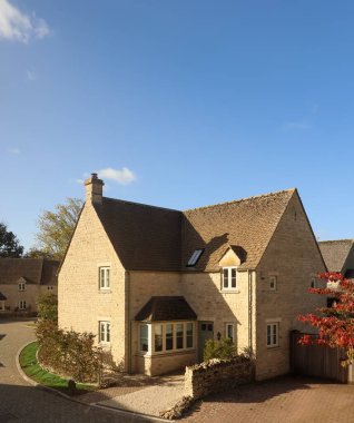 Traditional architecture of a stone house with pitched roof in a charming English village. Cotswolds countryside, England