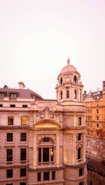 Londra binası rafine klasik mimari, kubbeli kubbe ve kış akşamı gökyüzü altındaki zarif detaylar.