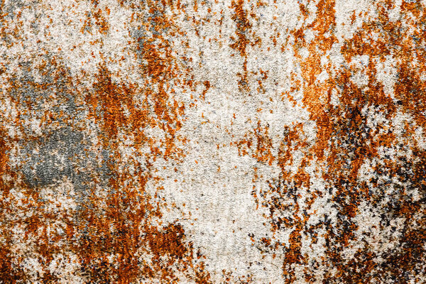 Rusted metal surface showing abstract grunge and weathered corrosion patterns. Old industrial material texture with decay
