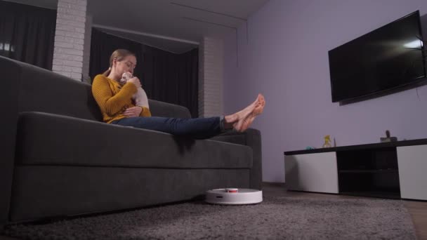 Happy woman petting puppy while hoover cleaning — Αρχείο Βίντεο