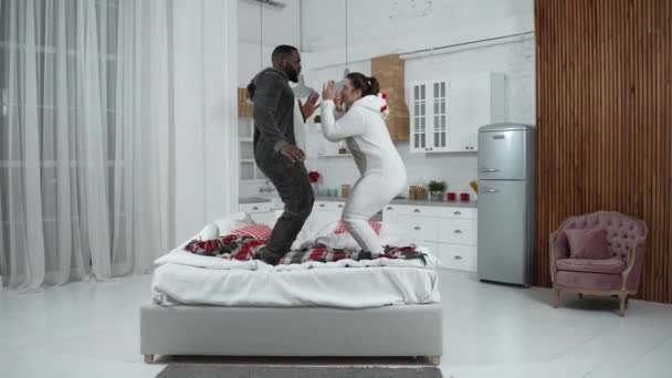 恋爱中快乐的夫妻在床上跳着时尚的舞 — 图库视频影像