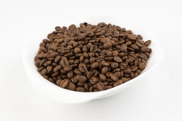 White plate full of coffee beans — Stock Photo, Image