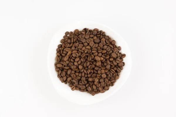 White plate full of coffee beans — Stock Photo, Image