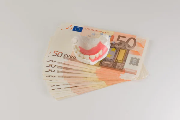 Dentures and cash — Stock Photo, Image
