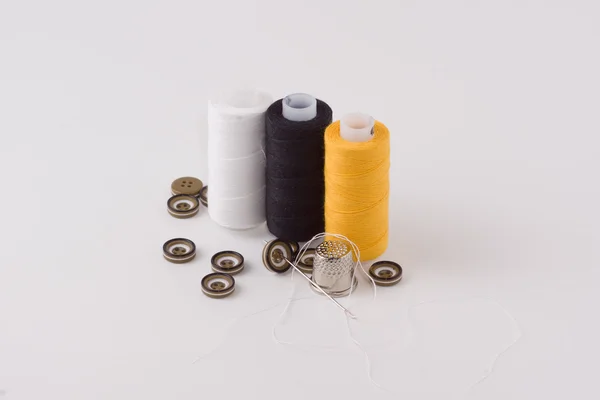 Buttons with a thread and a needle — Stock Photo, Image