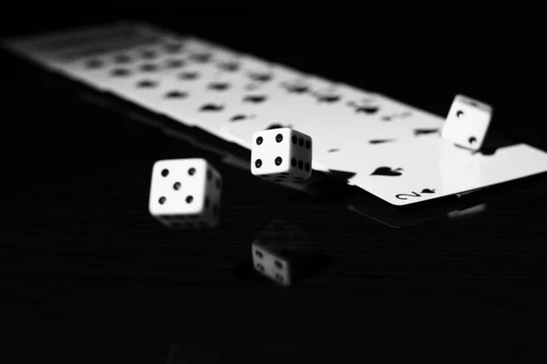 Gaming dice and a row of playing cards. — Stock Photo, Image