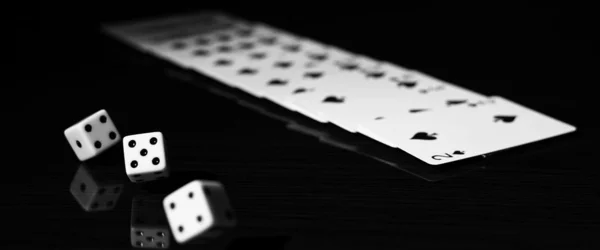 Gaming dice and a row of playing cards. — Stock Photo, Image