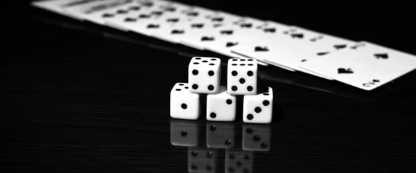 Gaming dice and a row of playing cards. — Stock Photo, Image