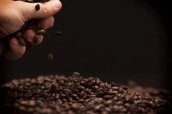 Hand grabbing coffee beans. — Stock Photo, Image