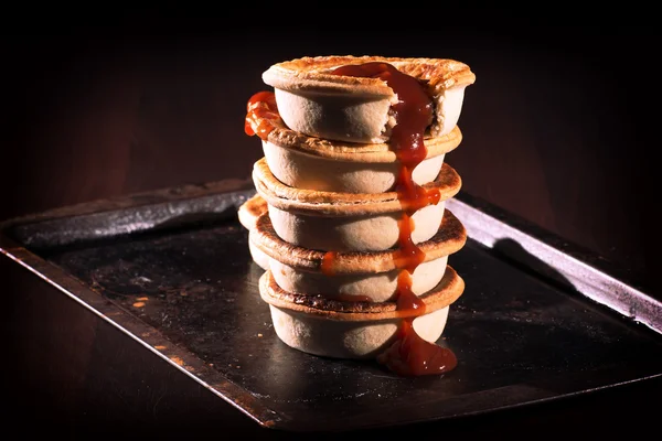 Meat Pies with sauce and high contrast lighting. — Stock Photo, Image