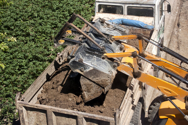 Excavator and dump truck