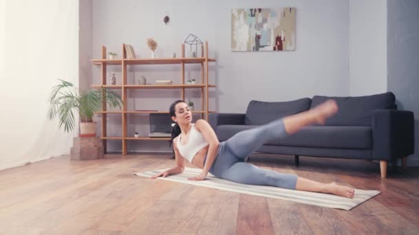 Barefoot Sportswoman Training Leg While Lying Fitness Mat Home — Stock Video