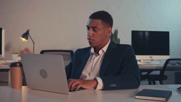 African American Businessman Typing Laptop Drinking Coffee Night — Vídeos de Stock