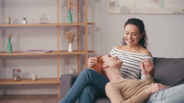 Happy Hispanic Woman Looking Redhead Girlfriend Living Room — Stock Video
