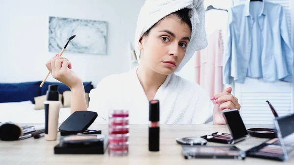 Young Woman Bathrobe Head Wrapped Towel Holding Eyebrow Brush Table — Stock Photo, Image