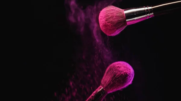 Cosmetic Brushes Bright Pink Holi Powder Dust Splashing Black Background — Stock Photo, Image