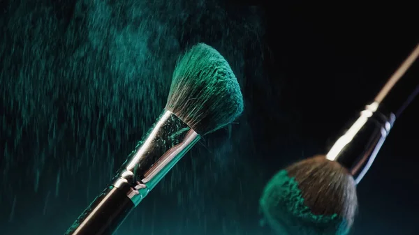 Cosmetic Brushes Bright Turquoise Holi Paint Dust Splash Black Background — Stock Photo, Image