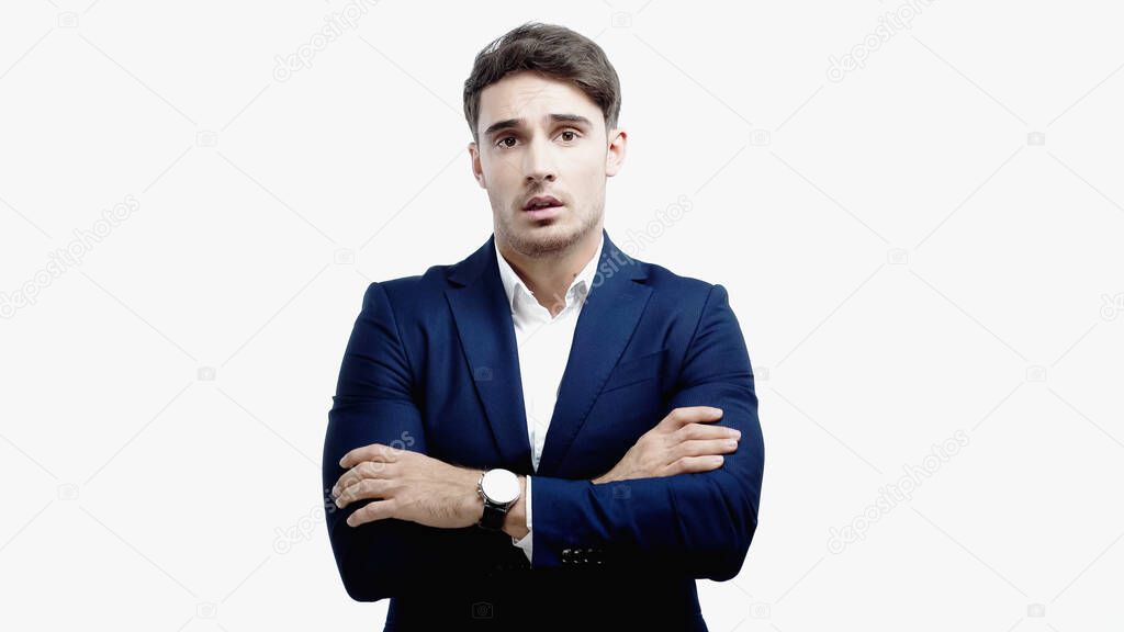Businessman with crossed arms looking at camera isolated on white 