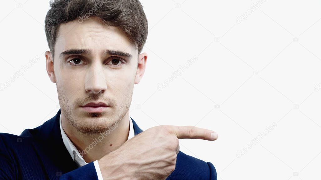 Businessman looking at camera and pointing with finger isolated on white