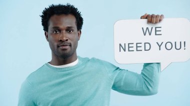 african american employer holding speech bubble with we need you lettering isolated on blue