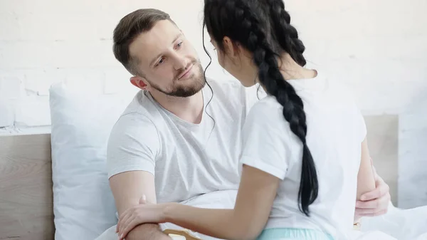 Caring Man Hugging Girlfriend Braids Bedroom — Stock Photo, Image