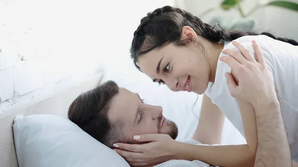 Smiling Young Woman Touching Face Bearded Man Bedroom — Photo