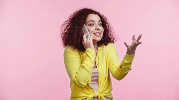 Молодая Веселая Женщина Жестикулирует Разговаривая Смартфоне Изолированы Розовый — стоковое фото