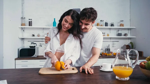 Happy Man Hugging Sexy Woman Shirt Bra Cutting Orange Kitchen — Stock Photo, Image