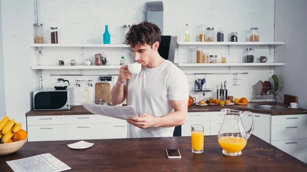 Young Man White Shirt Drinking Coffee Reading Newspaper Kitchen — Stock Photo, Image