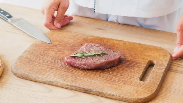 Partial View Chef Standing Beef Steak Rosemary Branch Chopping Board — Stock Photo, Image