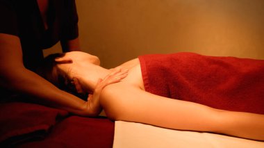 Kadın, spa salonundaki profesyonel masörden boyun masajı alıyor.
