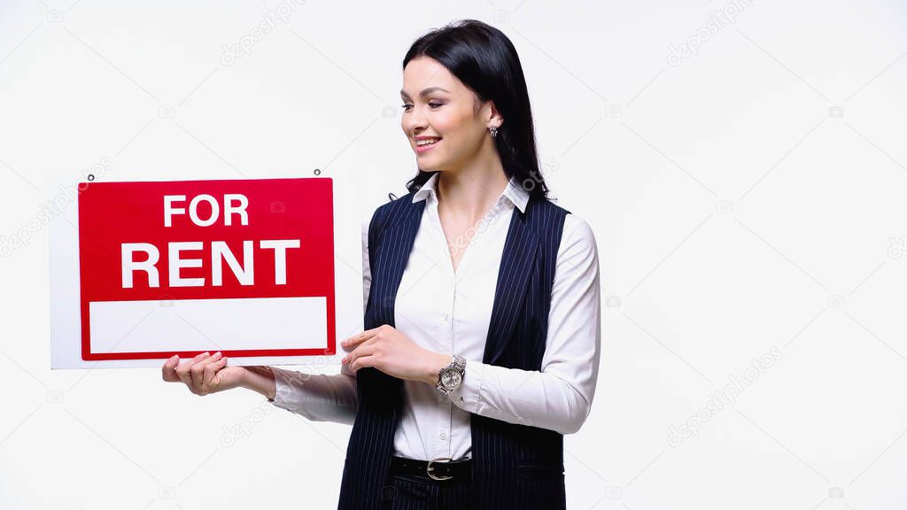 Smiling realtor holding signboard with for rent lettering isolated on white
