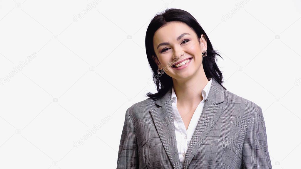 Brunette woman in formal wear smiling at camera isolated on white 