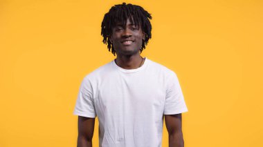 Gülümseyen mutlu Afro-Amerikalı adam, sarıda izole edilmiş rastalı saçlarıyla.