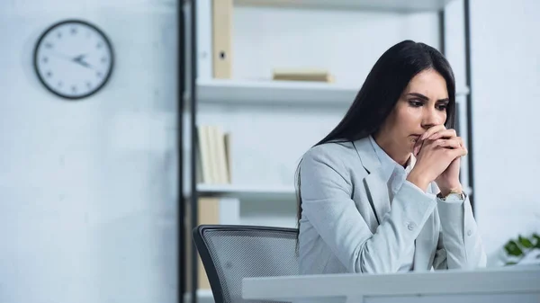 Worried Businesswoman Clenched Hands Sitting Desk — 스톡 사진