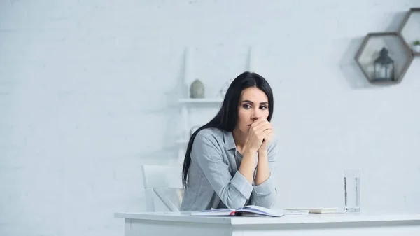 Worried Businesswoman Clenched Hands Sitting Desk Office — 스톡 사진