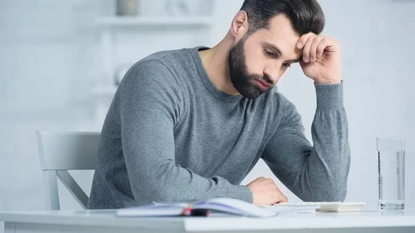 Displeased Man Puffing Cheeks Looking Calculator Table — Stock Photo, Image