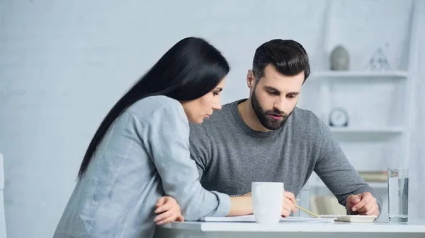 Couple Discussing Finances Looking Calculator Table — 스톡 사진