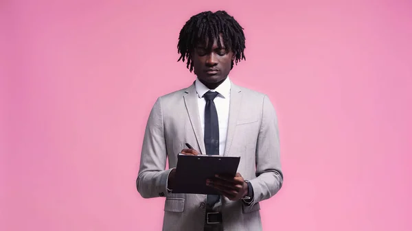 African American Businessman Writing Clipboard Isolated Pink — Stock Photo, Image